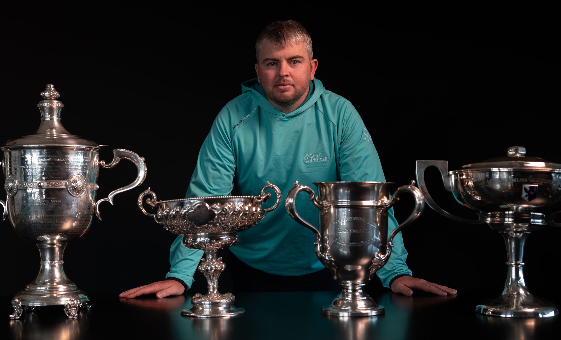 Golfer behind the four provincial trophies, from the Irish Golfer cover shoot