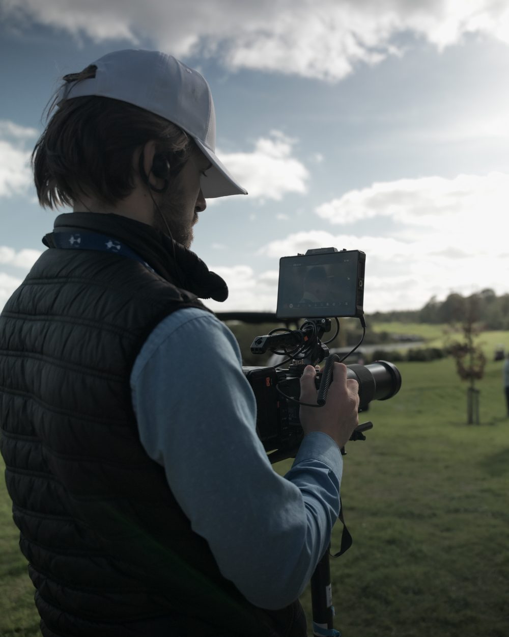 Operator in a Blue Motion Media gilet checking the monitor at the PGA Cup 2026